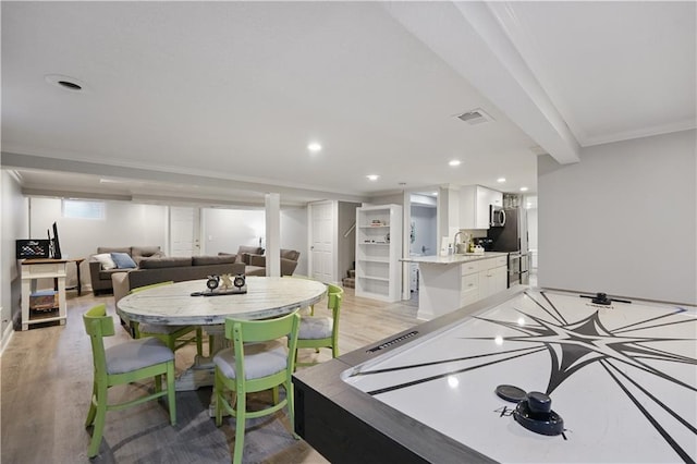 9849 Riggs St, Overland Park, KS 66212 - recreation room featuring ornamental molding, light wood-style flooring, recessed lighting, and a sink