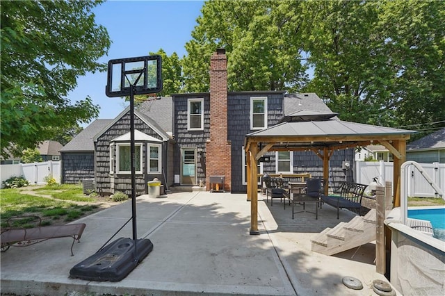 9849 Riggs St, Overland Park, KS 66212 - rear view of property featuring a gazebo, a chimney, a fenced backyard, and a patio area