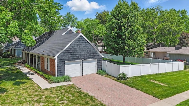 9849 Riggs St, Overland Park, KS 66212 - view of front of home featuring a chimney, decorative driveway, and an attached garage