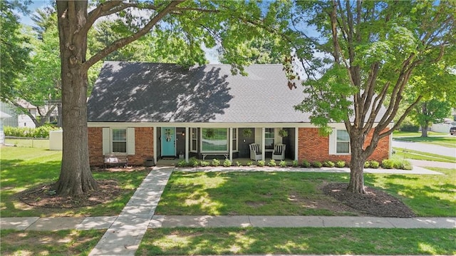 9849 Riggs St, Overland Park, KS 66212 - view of front of house featuring a front yard, brick siding, and covered porch