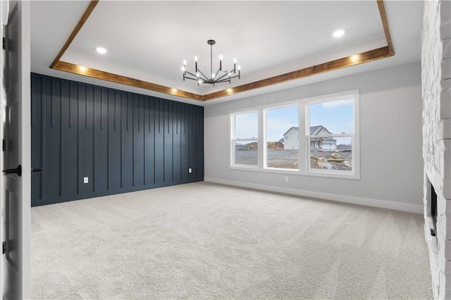 18464 Windsor St, Overland Park, KS 66085 - carpeted empty room with a raised ceiling, a chandelier, baseboards, and recessed lighting