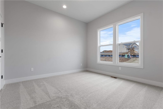 18464 Windsor St, Overland Park, KS 66085 - spare room with baseboards, light carpet, and recessed lighting