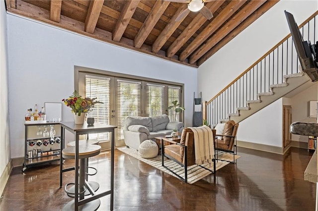 living area with wood ceiling, stairs, beam ceiling, high vaulted ceiling, and a ceiling fan