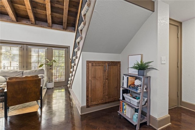 stairway featuring wood finished floors, lofted ceiling, and baseboards
