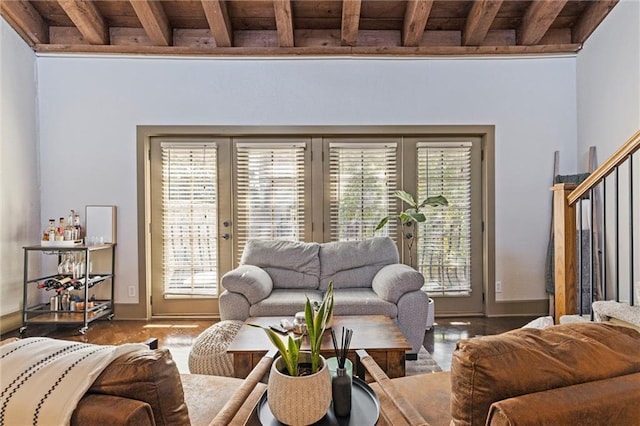 living area with wood ceiling, beamed ceiling, and wood finished floors