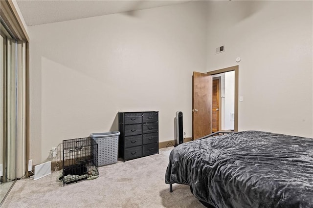 bedroom featuring carpet flooring and high vaulted ceiling