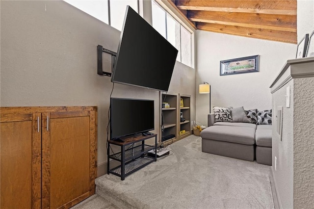 living area with carpet, beam ceiling, and high vaulted ceiling