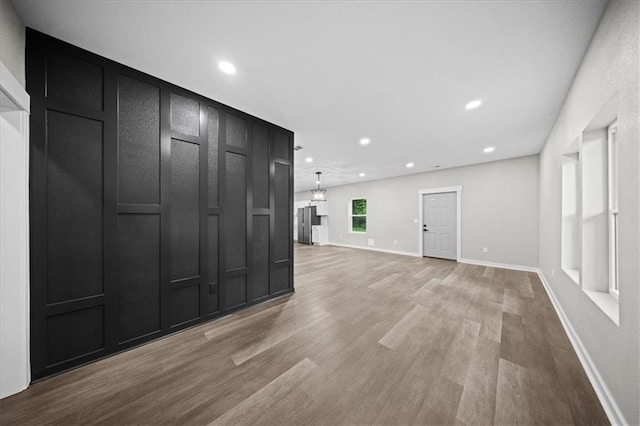 6339 Harris Ave, Raytown, MO 64133 - unfurnished living room featuring light wood-type flooring, recessed lighting, and baseboards