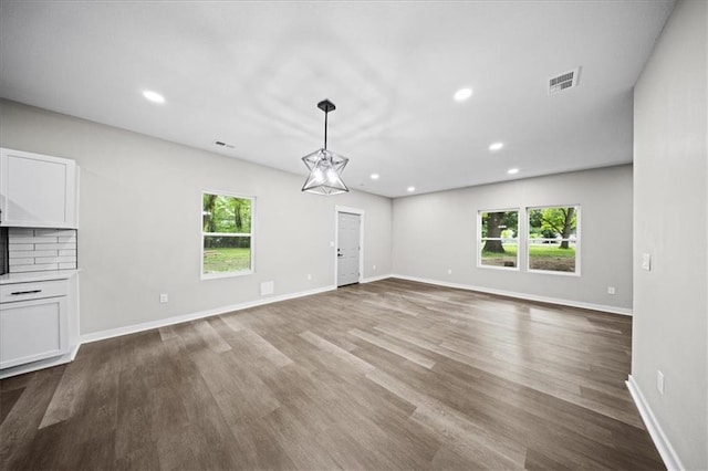 6339 Harris Ave, Raytown, MO 64133 - unfurnished living room featuring wood finished floors, recessed lighting, and baseboards