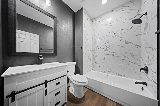 6339 Harris Ave, Raytown, MO 64133 - bathroom featuring a textured wall, wood finished floors, vanity, toilet, and shower / bathtub combination