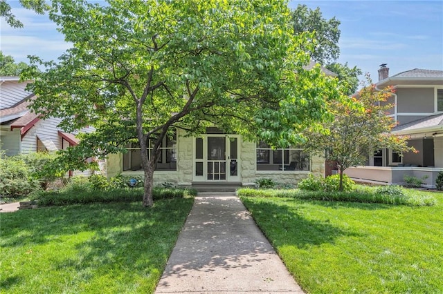 605 W 59th Ter, Kansas City, MO 64113 - view of property hidden behind natural elements featuring stone siding and a front lawn