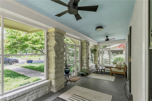 605 W 59th Ter, Kansas City, MO 64113 - sunroom featuring a ceiling fan, concrete floors, and plenty of natural light