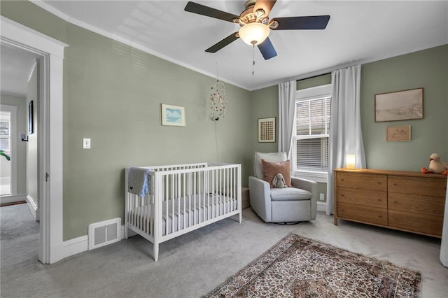 605 W 59th Ter, Kansas City, MO 64113 - bedroom with carpet floors, a nursery area, crown molding, and ceiling fan