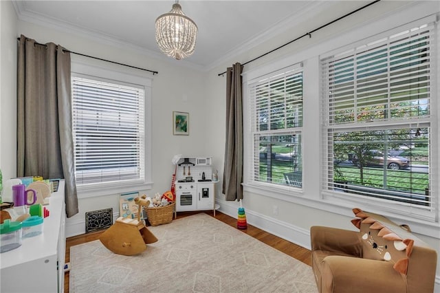 605 W 59th Ter, Kansas City, MO 64113 - rec room featuring a chandelier, ornamental molding, and wood finished floors
