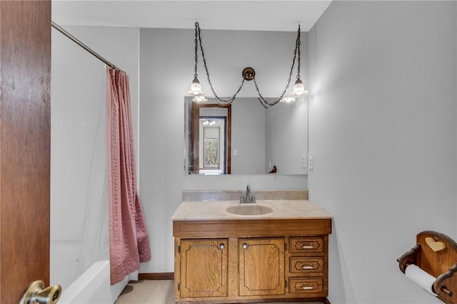 full bathroom with vanity and baseboards