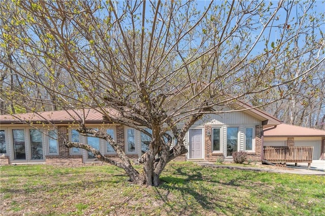 ranch-style home with brick siding and a front lawn