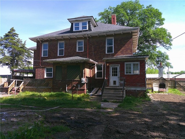 1107 Central St, Humboldt, KS 66748 - back of property with brick siding and a chimney