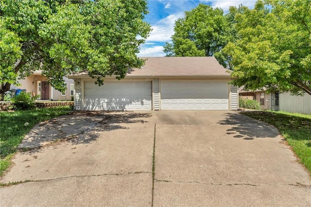 view of property hidden behind natural elements featuring driveway