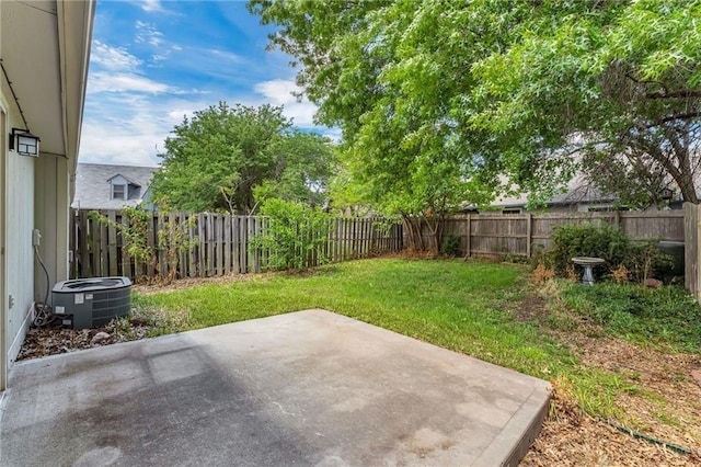 view of yard featuring central AC unit and a patio area
