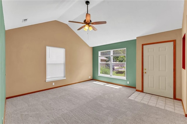 carpeted foyer entrance featuring a ceiling fan, vaulted ceiling, and baseboards