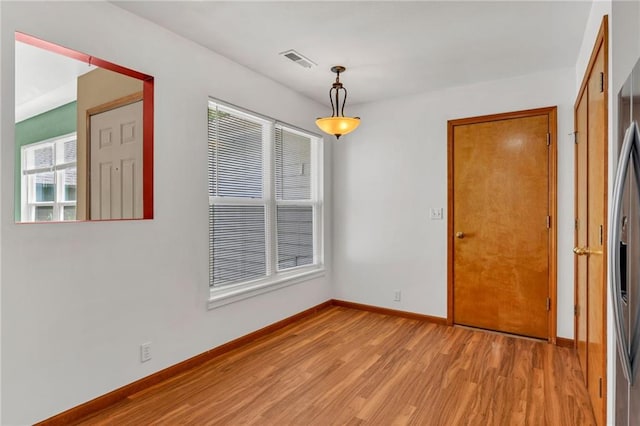 empty room with light wood-type flooring and baseboards