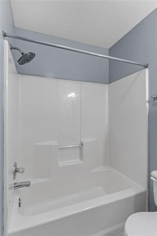 bathroom with toilet and bathtub / shower combination