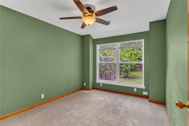 unfurnished room with carpet floors, baseboards, and ceiling fan