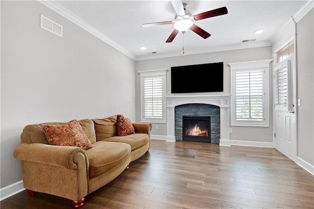 15908 Fontana St Unit 240, Overland Park, KS 66085 - living area featuring plenty of natural light, ceiling fan, ornamental molding, a glass covered fireplace, and wood finished floors