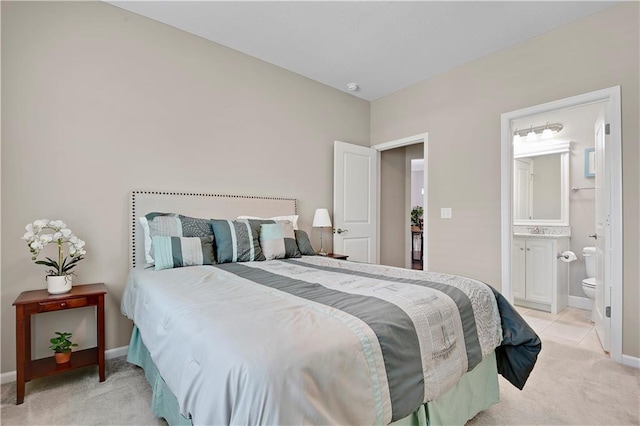 15908 Fontana St Unit 240, Overland Park, KS 66085 - bedroom with light colored carpet, baseboards, a sink, and ensuite bath