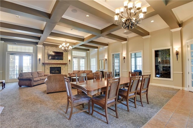15908 Fontana St Unit 240, Overland Park, KS 66085 - carpeted dining room featuring a chandelier, a fireplace, coffered ceiling, beam ceiling, and plenty of natural light