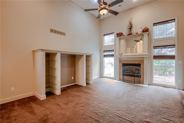 7100 N Cherry St, Gladstone, MO 64118 - unfurnished living room with ceiling fan, carpet floors, ornamental molding, a towering ceiling, and baseboards