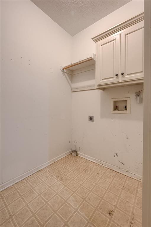 7100 N Cherry St, Gladstone, MO 64118 - laundry area featuring light floors, electric dryer hookup, washer hookup, cabinet space, and a textured ceiling