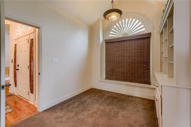 7100 N Cherry St, Gladstone, MO 64118 - unfurnished room with carpet flooring, baseboards, and lofted ceiling
