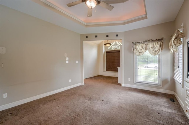 7100 N Cherry St, Gladstone, MO 64118 - empty room with carpet flooring, a ceiling fan, a raised ceiling, and baseboards