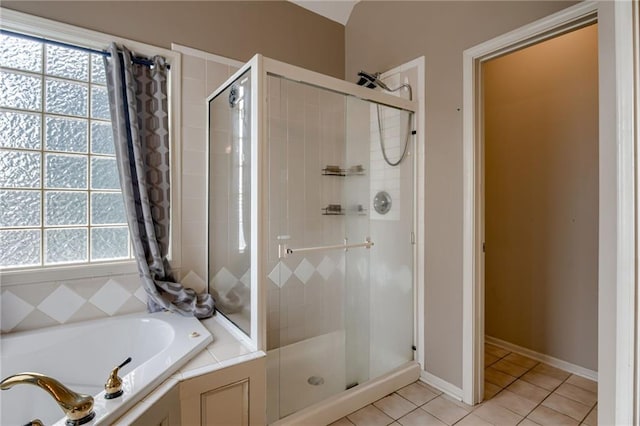 7100 N Cherry St, Gladstone, MO 64118 - full bath with a stall shower, tile patterned flooring, plenty of natural light, and a garden tub