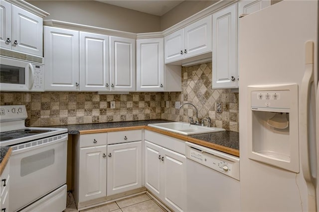 7100 N Cherry St, Gladstone, MO 64118 - kitchen with white appliances, a sink, dark countertops, and white cabinetry