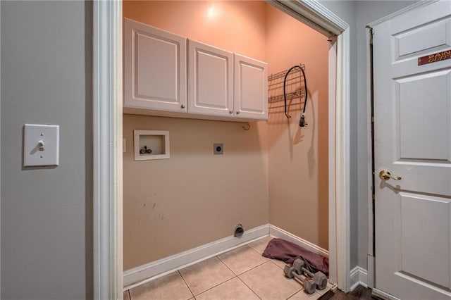 7100 N Cherry St, Gladstone, MO 64118 - laundry area with cabinet space, light tile patterned floors, electric dryer hookup, baseboards, and washer hookup