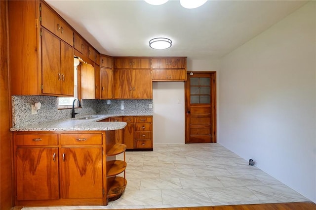 3001 S Hardy Ave, Independence, MO 64052 - kitchen featuring a sink, brown cabinets, backsplash, a peninsula, and open shelves