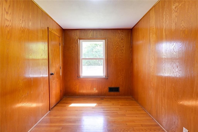 3001 S Hardy Ave, Independence, MO 64052 - spare room with light wood-style flooring and wood walls
