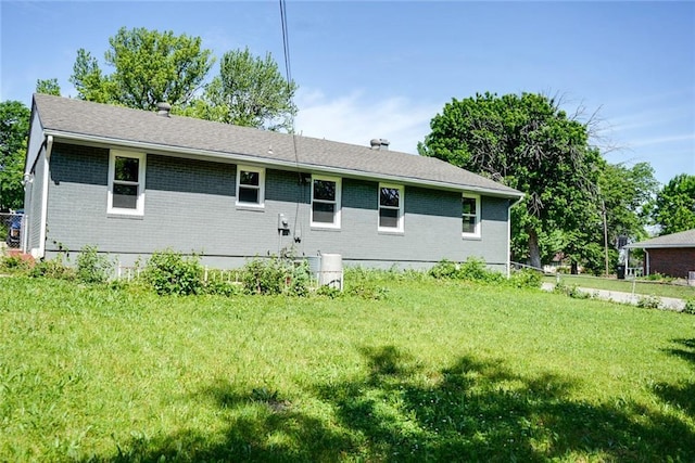 3001 S Hardy Ave, Independence, MO 64052 - back of property featuring brick siding and a lawn