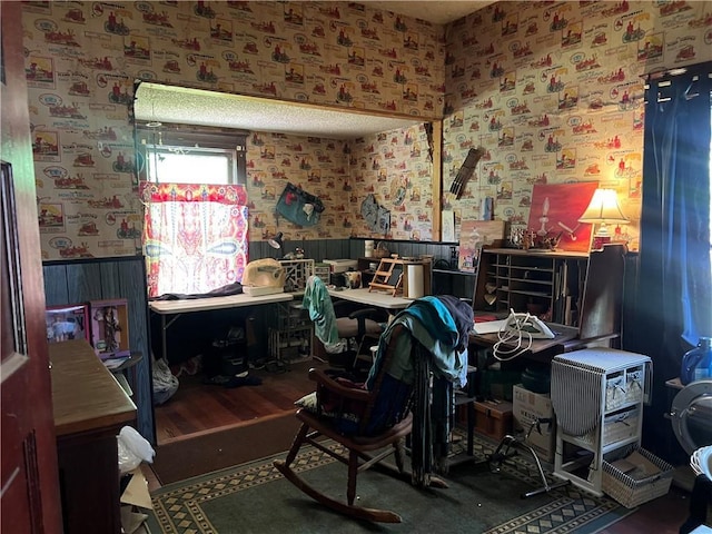 office space with wallpapered walls and a wainscoted wall
