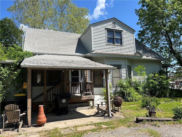 view of front of property featuring a shingled roof and a porch