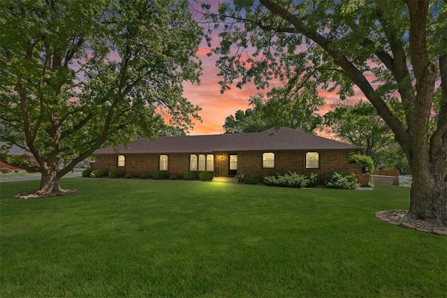 2107 N 154th Ter, Basehor, KS 66007 - ranch-style house with a lawn and brick siding
