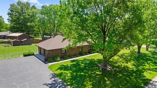 2107 N 154th Ter, Basehor, KS 66007 - view of side of property featuring a garage, brick siding, and asphalt driveway