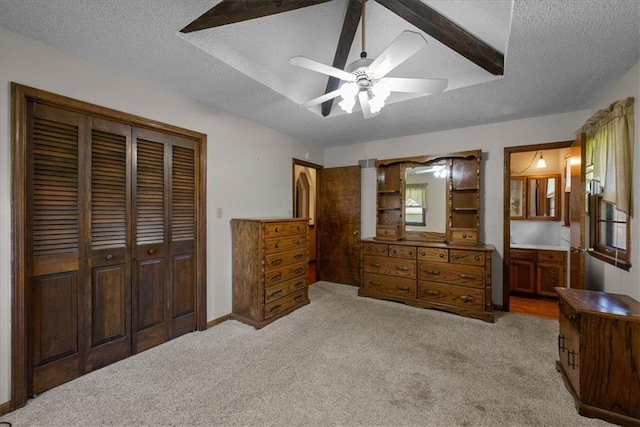 2107 N 154th Ter, Basehor, KS 66007 - bedroom featuring light carpet, a closet, a textured ceiling, ceiling fan, and ensuite bath