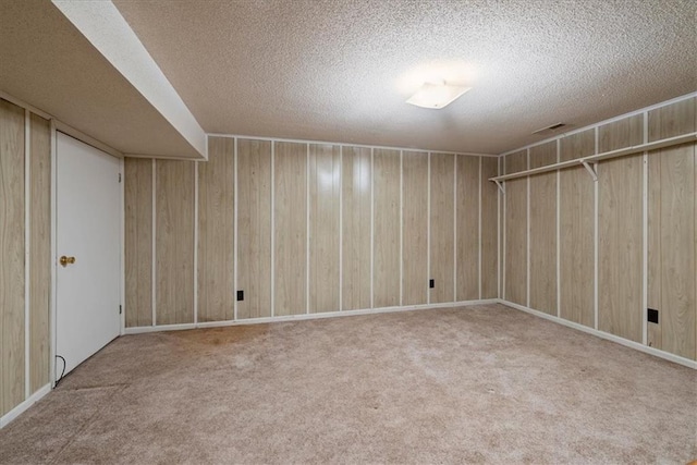 2107 N 154th Ter, Basehor, KS 66007 - finished below grade area with a textured ceiling, carpet, and wooden walls