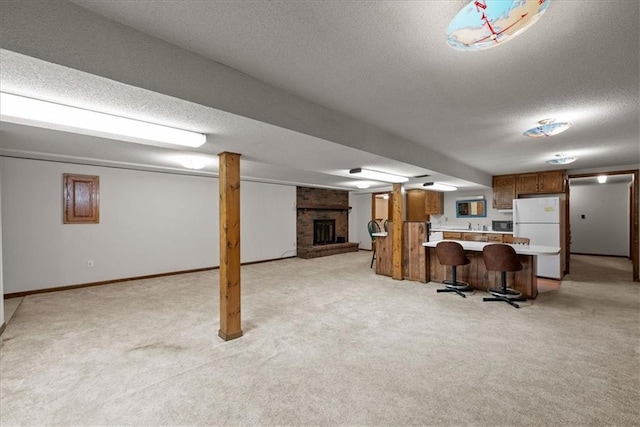 2107 N 154th Ter, Basehor, KS 66007 - kitchen with freestanding refrigerator, light countertops, a textured ceiling, open floor plan, and light carpet