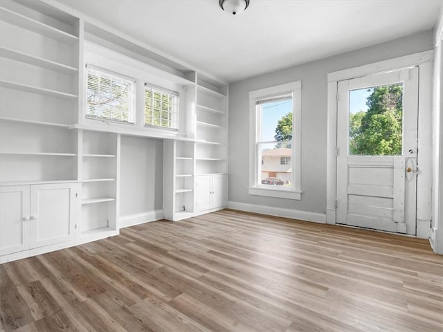 unfurnished bedroom with wood finished floors and baseboards