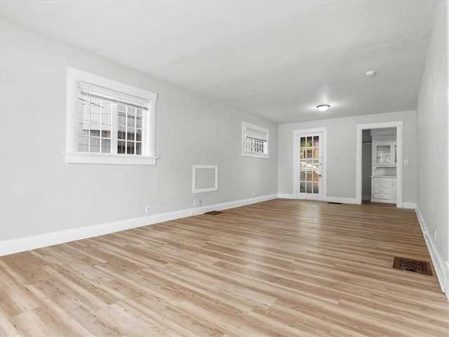 empty room with light wood-style flooring and baseboards