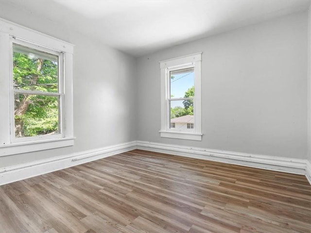 unfurnished room featuring wood finished floors and baseboards